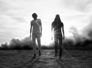 Black and white photo of two Black Pistol Fire musicians walking toward the camera