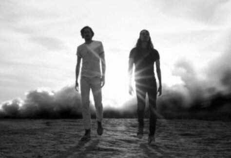 Black and white photo of two Black Pistol Fire musicians walking toward the camera