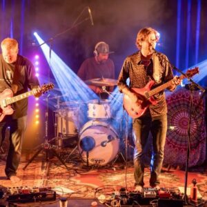 Members of Joint Point band on stage with colored lights