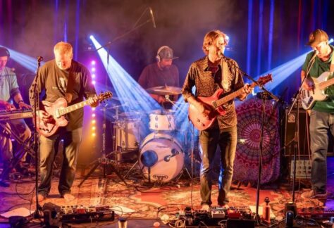 Members of Joint Point band on stage with colored lights