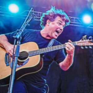 Photo of Keller Williams on stage singing with guitar