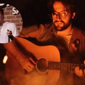 Emery Major with David Uhlfelder photo of man playing guitar