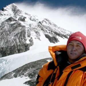 Photo of Pem Dorjee Sherpa in parka on snowy peak